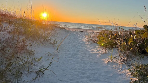 A sandy beach path leading to the ocean with sparse vegetation. - Beautiful Pool Home, 6 Min. to Beaches, Sleeps 8, Great for Families! (Largo)