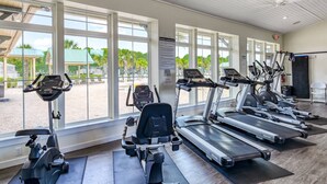 A fitness center with treadmills, elliptical machines, and a rowing machine. - Wynfield Place (St. Augustine)