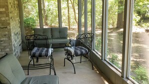 A covered porch with a ceiling fan, a sofa, and two chairs. - Little Getaway Paradise on the Golf Course w/Resort Amenities! (Holly Lake Ranch)