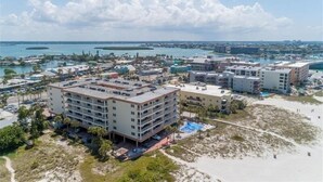 An aerial view of a coastal hotel with multiple buildings, a beach, and a marina. - Madeira Norte - The Perfect Beachfront Escape (Madeira Beach)