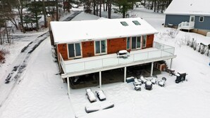 A two-story house with a covered garage and a balcony. - Sun Drenched Lakefront Cove (Thompson)