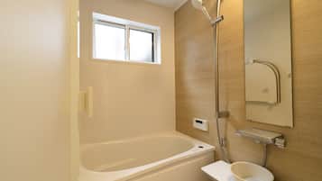 Bathtub, hair dryer, towels, soap