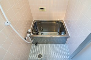 Bathtub, hair dryer, towels, soap