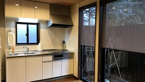 Una cocina moderna con un ventanal grande, suelo de madera y armarios empotrados.