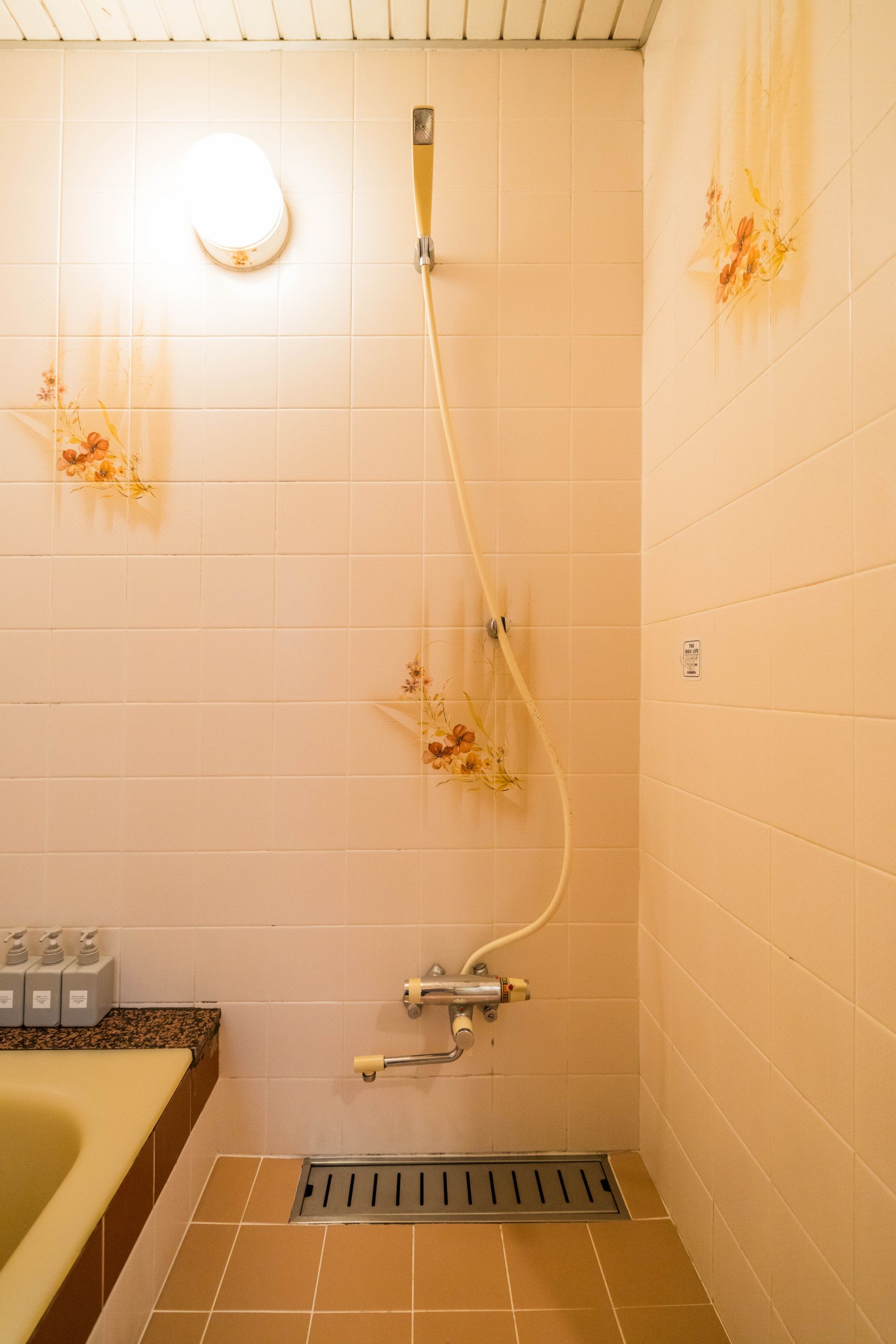 A bathroom with a shower, a toilet, and a sink.
