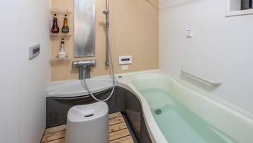 Bathtub, hair dryer, towels, soap