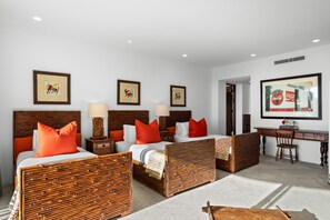 A hotel room with a large bed, two bedside tables, a desk, and a chair.