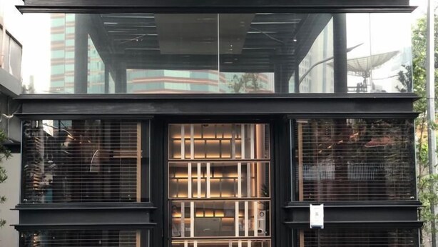 A modern building with a glass facade, large windows, and a wooden floor. - The Day Residence (Jakarta)