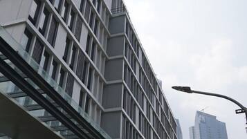 A modern building with a unique angular design, featuring multiple floors and large windows.