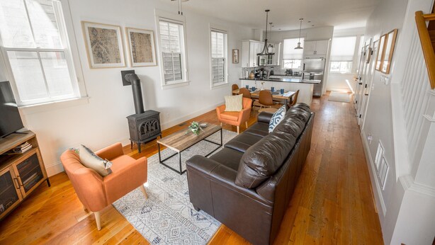 A spacious living room with a fireplace, a sofa, a coffee table, and a television. - Hot Tub;Mountain Views;steps from Arkansas River South Main (Buena Vista)