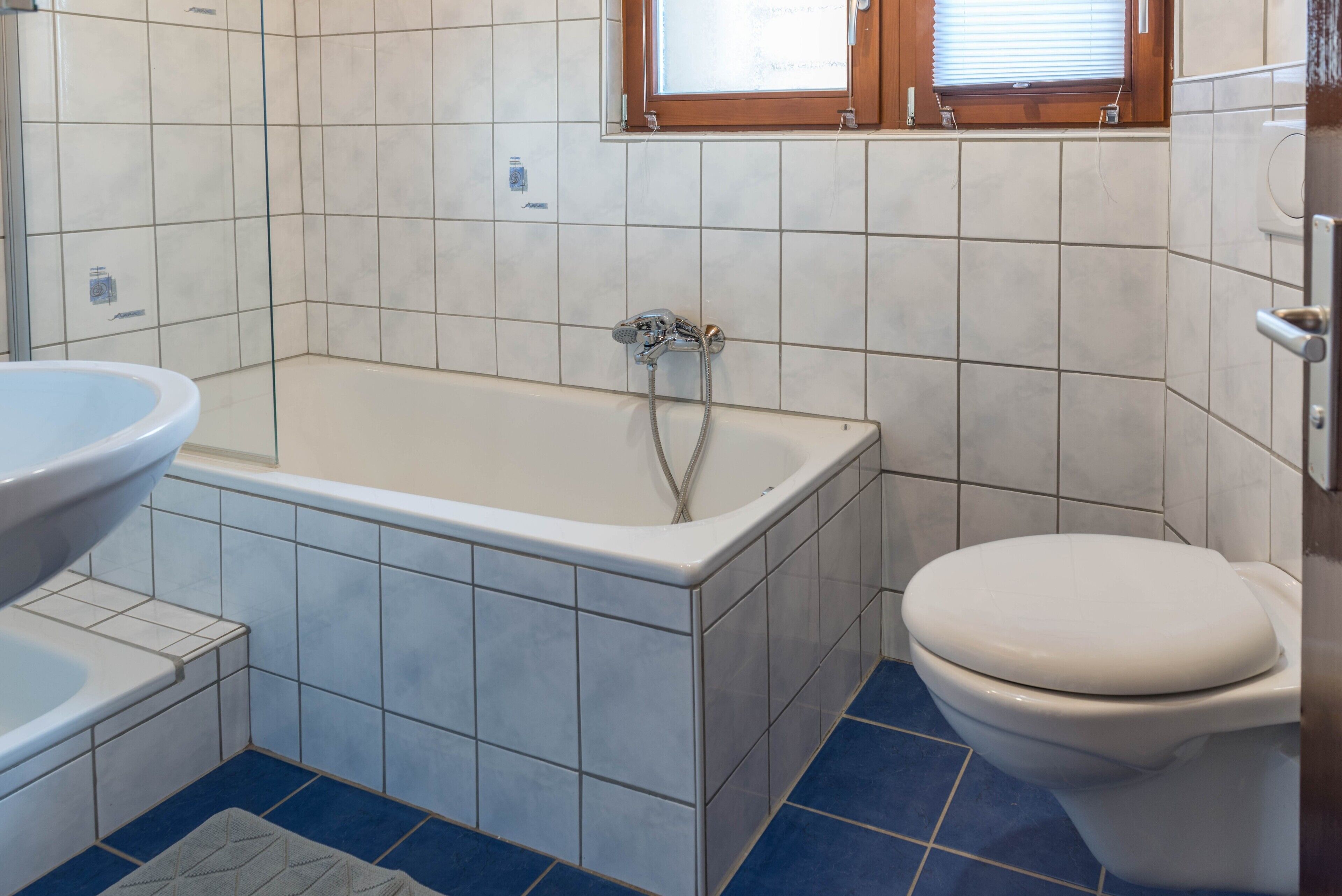 A bathroom with a bathtub, a sink, and a toilet.