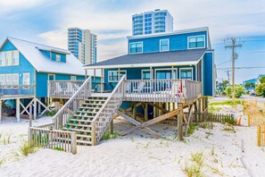 Enjoy beach access from elevated decks with multiple levels and staircases.