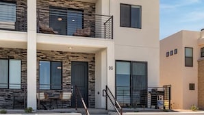 A modern two-story building with a stone facade, large windows, and a visible number '96'. - Chillin Out Maxin #96 by RedAwning (St. George)