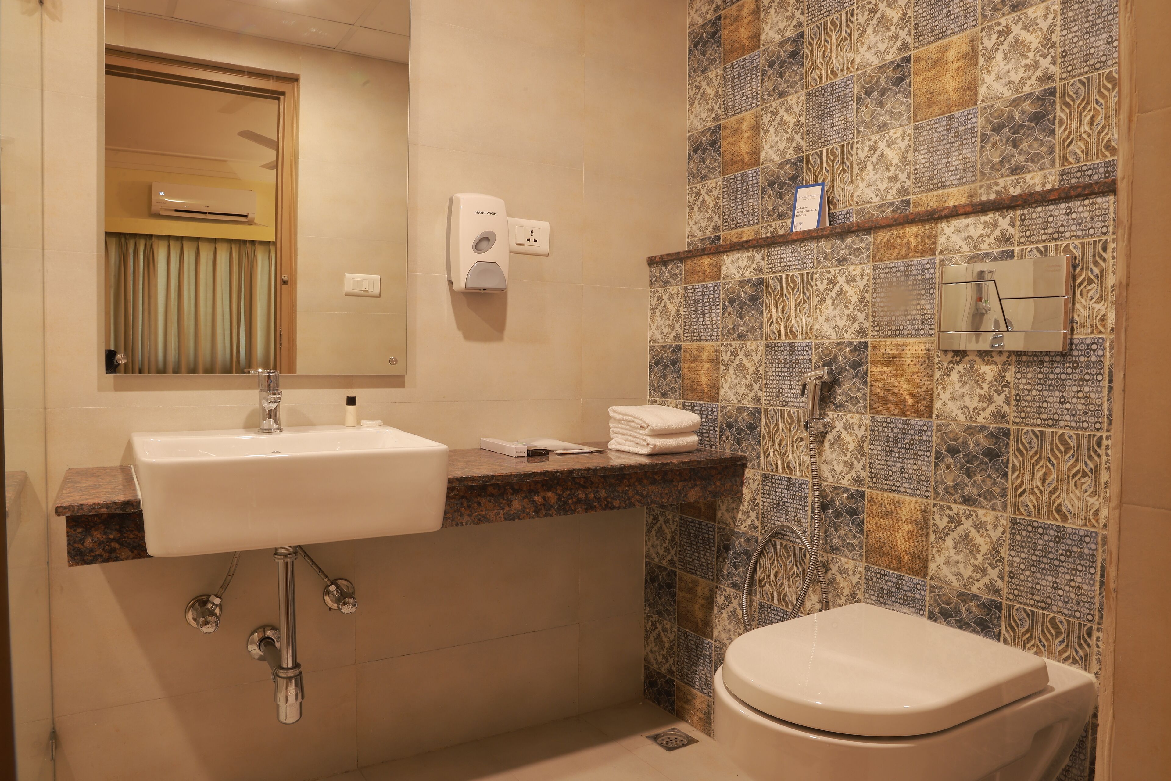 A bathroom with a sink, mirror, towel rack, and toilet.