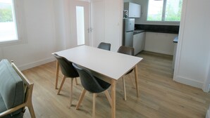 A modern kitchen with white cabinets and a black countertop. - Charming Renovated House: Close to Beach & Town Center, Modern Amenities (La Tranche-sur-Mer)
