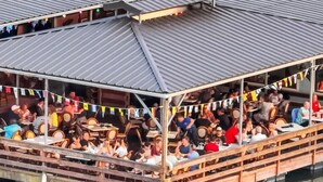 A covered dining area with tables and chairs, surrounded by a railing, overlooking a body of water. - BRAND NEW LISTING DISCOUNT - The Crow's Nest at Turtle Bay Marina (Old hickory)