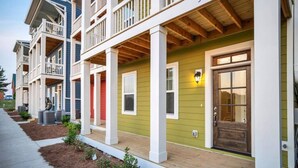 A row of multi-story residential buildings with balconies and a green facade. - BRAND NEW LISTING DISCOUNT - The Crow's Nest at Turtle Bay Marina (Old hickory)