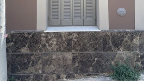 A building facade with a window featuring a set of double doors and a small ledge below. - Piraeus House With Sea View and Free Parking (Piraeus)