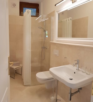 Shower, hair dryer, towels, toilet paper