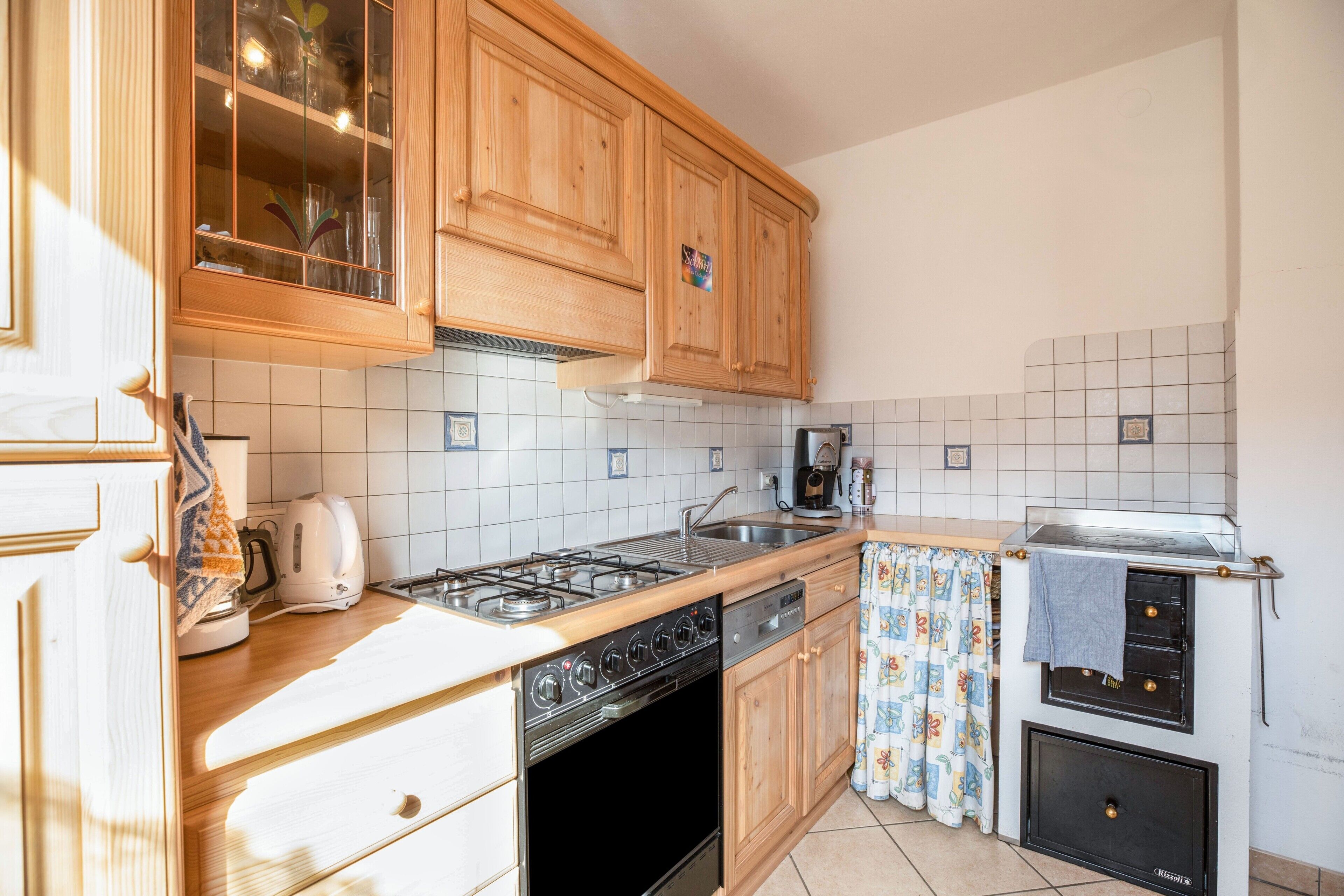 A kitchen with wooden cabinets, a gas stove, a dishwasher, and a built-in oven.