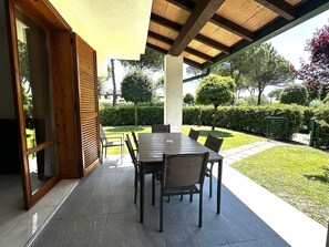 Relax in the serene garden, surrounded by lush greenery and a charming pergola.
