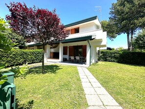 Enjoy a peaceful retreat in this charming home surrounded by mature trees and a well-maintained lawn.