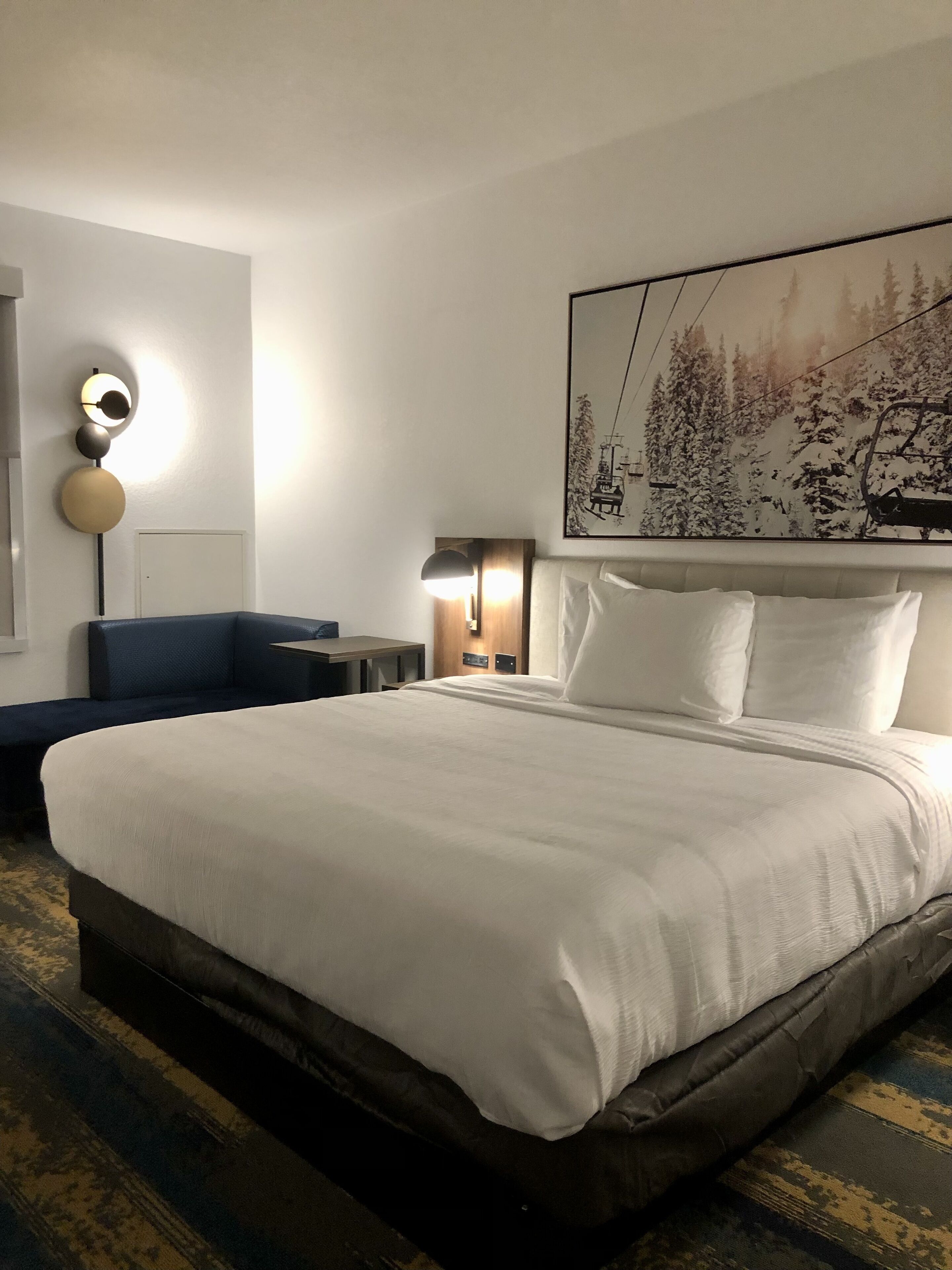 Premium bedding, desk, laptop workspace, blackout drapes