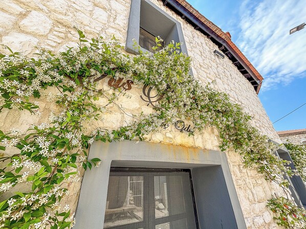 A stone building with a window and a balcony.