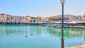 A waterfront with buildings, a lamp post, and boats. - Gorgeous Lake Kournas Villa Brand New Private Pool (Apokoronas)