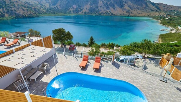 A pool area with lounge chairs and a view of a lake and mountains. - Stunning Lake Kournas Retreat 2 New Private Pool (Apokoronas)