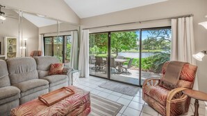 A spacious living room with a large sliding glass door leading to a patio area. - 3BD Villa Sandestin Resort, Golf Cart Included (Destin)