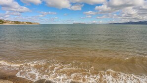 A coastal landscape with a clear sky and calm sea.