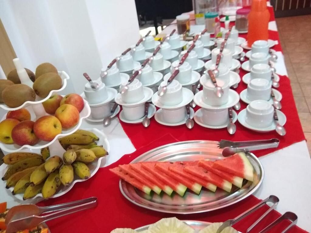 A buffet table with various fruits and bowls of food.