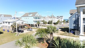 A residential street with houses, a clear sky, and a stop sign. - 4 BR Beach House with a Private Pool & Steps to the Beach! Seaborn (Surfside Beach)