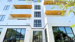 Un bâtiment moderne doté de grandes fenêtres et d’une façade plane.