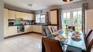 A modern kitchen with a dining area.