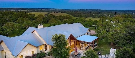 A large, modern house with multiple rooms and a spacious outdoor area.