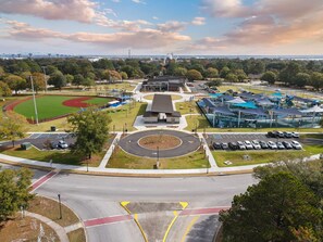 Experience the perfect blend of recreation and relaxation at this central facility, surrounded by a lush lawn and a baseball field.