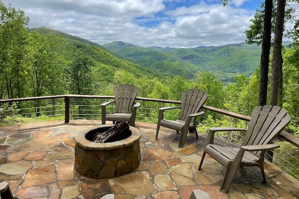 Custom stone firepit area overlooking mountains.