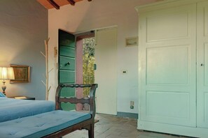 A bedroom with a bed, a chair, a wardrobe, and a door leading to a balcony. - Adults only. Air conditioning, Wi-Fi, pool, garden, parking. (Camaiore)