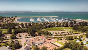 A marina with numerous boats docked, surrounded by residential areas and greenery. - RBR 232 - Beach Resort Kamperland (Kamperland)