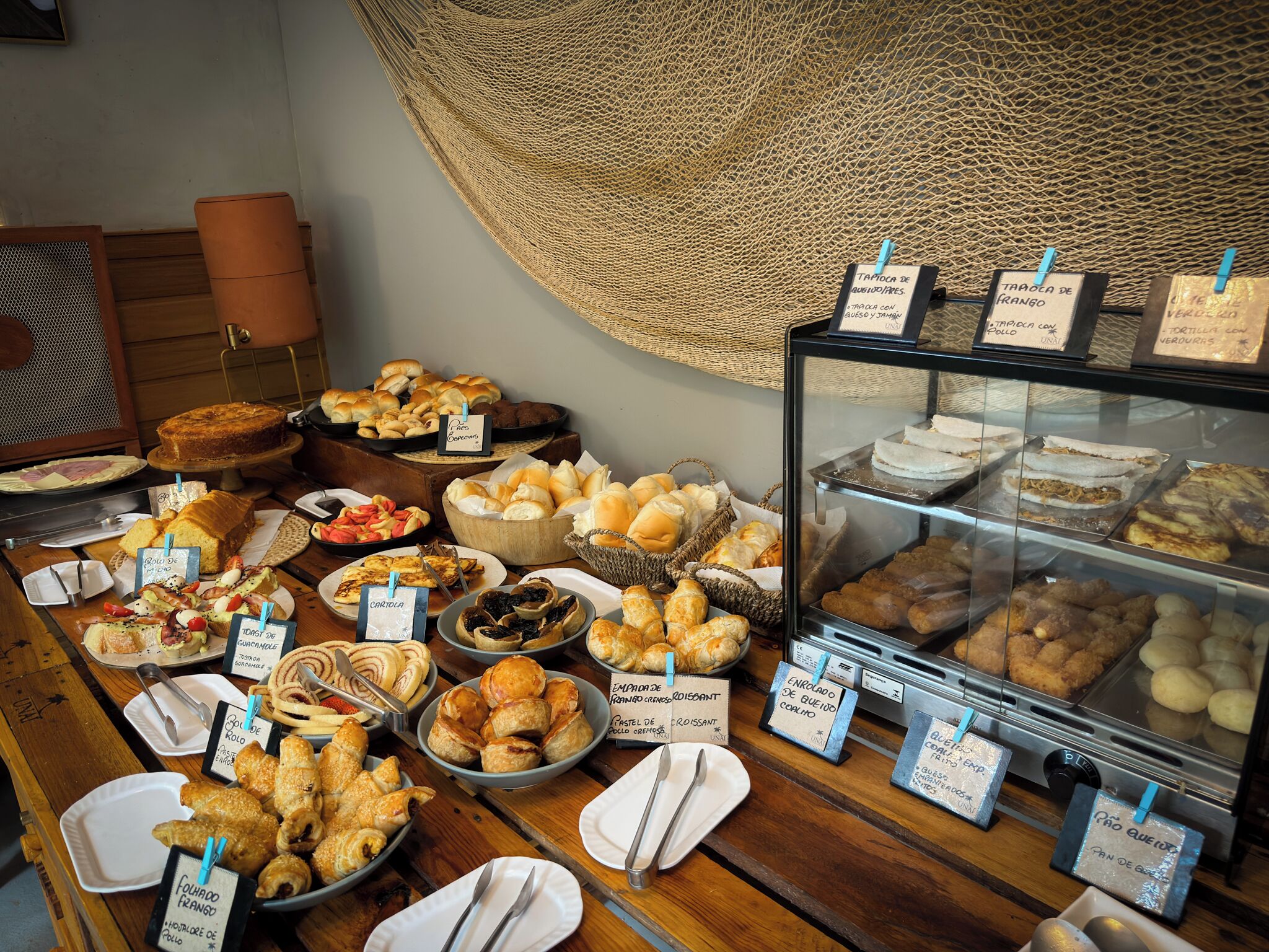 A buffet with various food items and labels in a restaurant setting.