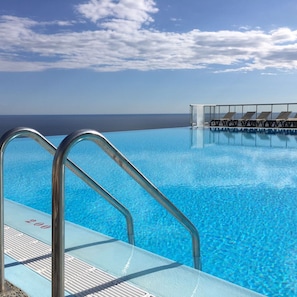 Seasonal outdoor pool, open 9:00 AM to 7:00 PM, pool umbrellas