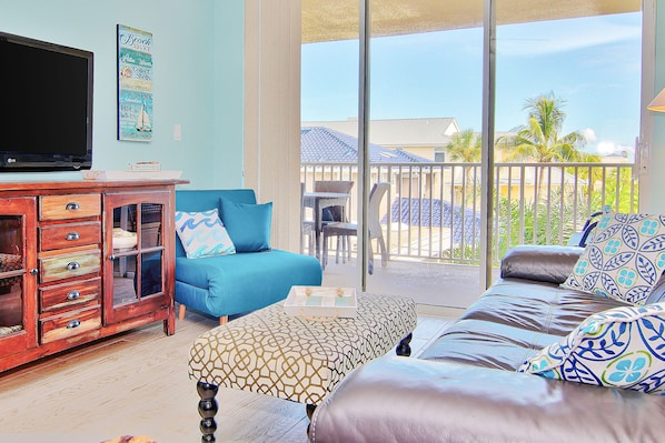 Relax in style with a comfortable sofa, flat-screen TV, and sliding glass door to an outdoor patio.