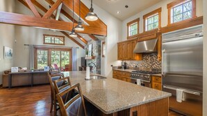 A spacious kitchen with wooden beams, granite countertops, and stainless steel appliances. - Central Location w/ Suncadia Pool Access (Cle Elum)