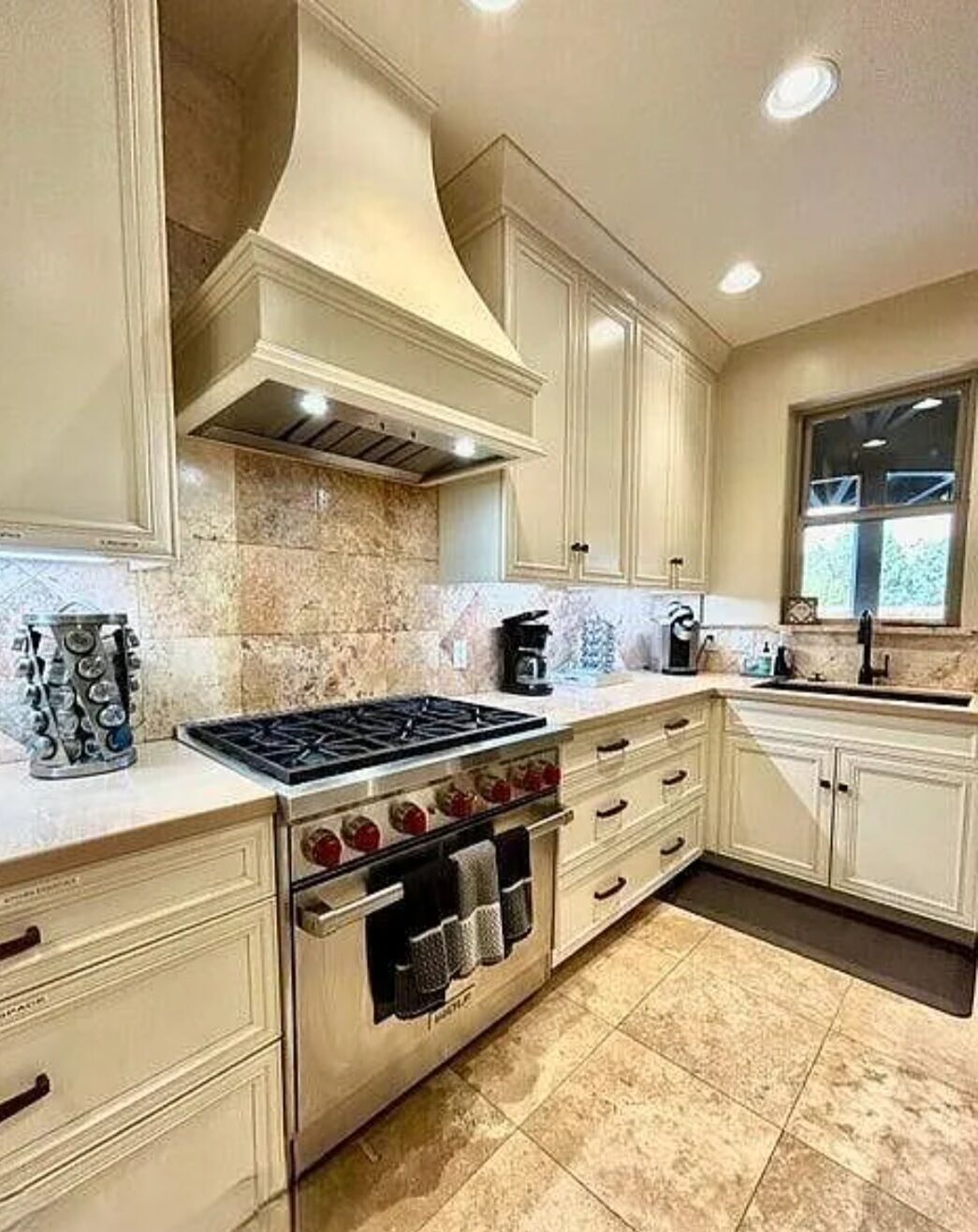 A kitchen with a stove, oven, and cabinets.