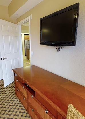 Enjoy a comfortable stay with a large flat-screen TV and ample storage in this well-appointed room.