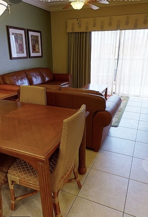 Relax in the living area with a large dining table and comfortable seating for gatherings.