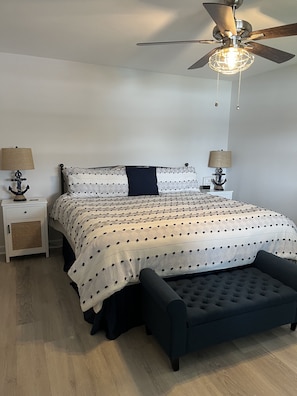 Relax in this serene bedroom with a comfortable bed and stylish seating area.