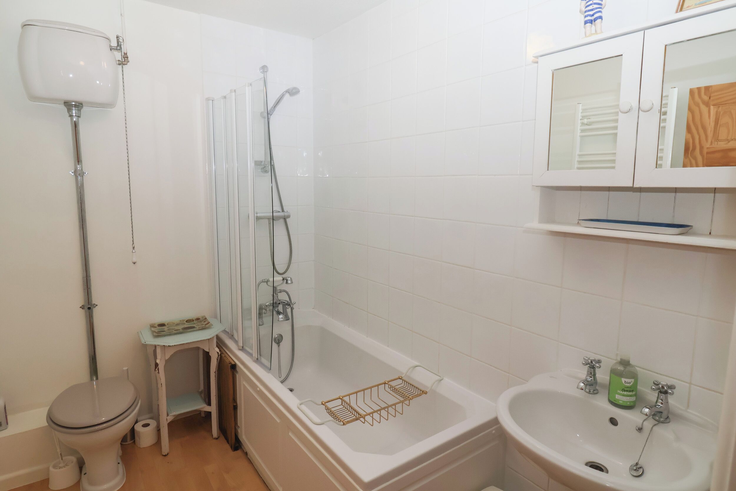 A bathroom with a toilet, a shower, a bathtub, and a sink.